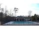 A community pool is enclosed with a black fence and features a covered pool house for community members at 532 Oakside Pl, Acworth, GA 30102