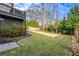 Green backyard features a lush lawn, partial black deck view, and mature landscaping at 2603 Apple Valley Ne Rd, Brookhaven, GA 30319