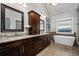 Luxurious bathroom showcasing dual vanities with granite countertops, a standalone tub, and modern fixtures for a spa-like experience at 2603 Apple Valley Ne Rd, Brookhaven, GA 30319