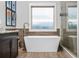 Modern bathroom featuring a sleek standalone bathtub next to a shower, complemented by contemporary fixtures and stylish tile work at 2603 Apple Valley Ne Rd, Brookhaven, GA 30319