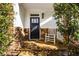 Charming front porch with stone flooring, accent wall, and a rocking chair at 2603 Apple Valley Ne Rd, Brookhaven, GA 30319