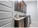 Functional laundry room features dark cabinets, a sink with counter space, and modern washer/dryer at 2603 Apple Valley Ne Rd, Brookhaven, GA 30319