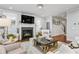Cozy living room with fireplace, plush rug, elegant furnishings, and ample natural light at 2603 Apple Valley Ne Rd, Brookhaven, GA 30319