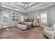Serene main bedroom with a large bed, neutral tones, ample natural light, and a comfortable sitting area by the windows at 2603 Apple Valley Ne Rd, Brookhaven, GA 30319