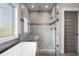 Contemporary shower features frameless glass, stylish tiling, a built-in bench, and natural light from an adjacent window at 2603 Apple Valley Ne Rd, Brookhaven, GA 30319
