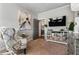 Cozy sitting room features modern decor, a stylish chair, and a decorative mirrored console with television at 2603 Apple Valley Ne Rd, Brookhaven, GA 30319