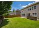 Spacious backyard with a well-kept lawn, stone patio, and an outdoor grill at 4652 Prater Se Way, Smyrna, GA 30080