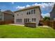 Expansive backyard featuring an outdoor stone grill, patio, and lush green lawn at 4652 Prater Se Way, Smyrna, GA 30080