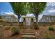 Backyard featuring tiered retaining walls, and lush landscaping and grass at 4652 Prater Se Way, Smyrna, GA 30080