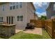 Well-manicured backyard with a stone grill, a wooden fence, and paved pathway at 4652 Prater Se Way, Smyrna, GA 30080