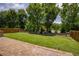 Spacious backyard featuring lush lawn, and stone paver patio at 4652 Prater Se Way, Smyrna, GA 30080
