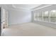 Light-filled bedroom with neutral carpet, tray ceiling and large windows at 4652 Prater Se Way, Smyrna, GA 30080