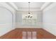 Elegant dining room with hardwood floors, crown molding, and a stylish chandelier at 4652 Prater Se Way, Smyrna, GA 30080