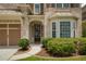 Close-up of the front entrance showing the door, manicured landscaping, and bay window at 4652 Prater Se Way, Smyrna, GA 30080