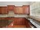 Close-up of updated kitchen with granite countertops, stainless steel appliances, and wood cabinetry at 4652 Prater Se Way, Smyrna, GA 30080