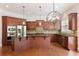 Updated kitchen with stainless steel appliances, granite counters, and a stylish light fixture at 4652 Prater Se Way, Smyrna, GA 30080