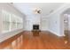 Cozy living room featuring hardwood floors, a fireplace, built-in shelving, and natural light at 4652 Prater Se Way, Smyrna, GA 30080