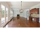 Open living room has a fireplace, built-in shelving, French doors, and an elegant light fixture at 4652 Prater Se Way, Smyrna, GA 30080