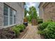 Brick pathway alongside home with lush landscaping and wooden fence entry at 4652 Prater Se Way, Smyrna, GA 30080