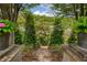 Stone walkway between retaining walls with manicured green foliage at 4652 Prater Se Way, Smyrna, GA 30080