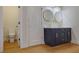 Updated bathroom featuring double sinks, navy vanity and gold accents at 553 Somersby Dr, Dallas, GA 30157