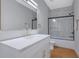 Modern bathroom features a white vanity with gold fixtures and a tiled shower/tub at 553 Somersby Dr, Dallas, GA 30157