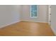 Bedroom with hardwood floors, neutral walls, and a large window at 553 Somersby Dr, Dallas, GA 30157