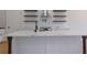 Spacious kitchen island with white countertops, shelving, and stainless steel appliances at 553 Somersby Dr, Dallas, GA 30157