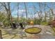 Secluded backyard with stone patio surrounded by mature trees and lush greenery at 698 Bellemeade Nw Ave, Atlanta, GA 30318