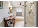 Well-lit bathroom featuring a glass-enclosed shower, a soaking tub, and a wood vanity at 698 Bellemeade Nw Ave, Atlanta, GA 30318