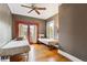 Cozy bedroom featuring hardwood floors, ceiling fan, and access to the outdoors through glass paneled doors at 698 Bellemeade Nw Ave, Atlanta, GA 30318