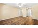 Spacious bedroom featuring wood floors, ceiling fan, closet, and view into the attached bathroom at 98 Hampshire Ct, Avondale Estates, GA 30002