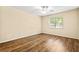 Bright bedroom featuring wood floors, ceiling fan, and large window at 98 Hampshire Ct, Avondale Estates, GA 30002