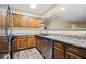 Cozy kitchen featuring wooden cabinetry, granite countertops, stainless steel appliances, and modern fixtures at 98 Hampshire Ct, Avondale Estates, GA 30002