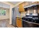 Well-lit kitchen with stainless steel appliances, wood cabinets, granite countertops, and wood flooring at 98 Hampshire Ct, Avondale Estates, GA 30002