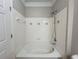 Bathtub with a shower and a tile surround at 1850 Cotillion Dr # 2416, Atlanta, GA 30338