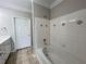 Bathroom features a white tiled tub with a shower at 1850 Cotillion Dr # 2416, Atlanta, GA 30338