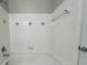 Bathroom features a white tiled tub with a shower at 1850 Cotillion Dr # 2416, Atlanta, GA 30338