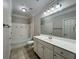 Well-lit bathroom featuring a bathtub, shower, toilet, white vanity and a large mirror at 1850 Cotillion Dr # 2416, Atlanta, GA 30338