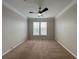 Neutral bedroom features a ceiling fan and a window to let in plenty of natural light at 1850 Cotillion Dr # 2416, Atlanta, GA 30338