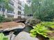 Scenic condominium with a beautiful pond, lush landscaping, and a charming wooden bridge at 1850 Cotillion Dr # 2416, Atlanta, GA 30338