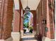 Inviting arched entryway with red brick columns and overhead lighting at 1850 Cotillion Dr # 2416, Atlanta, GA 30338
