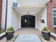 Secured building entrance with wrought iron gate and stylish potted plants at 1850 Cotillion Dr # 2416, Atlanta, GA 30338