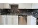 Modern kitchen featuring stainless steel appliances, granite countertops, and white cabinetry at 1850 Cotillion Dr # 2416, Atlanta, GA 30338