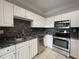 Modern kitchen featuring stainless steel appliances, granite countertops, and updated cabinets at 1850 Cotillion Dr # 2416, Atlanta, GA 30338