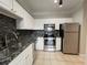 Updated kitchen with stainless steel appliances, modern cabinets, and granite counters at 1850 Cotillion Dr # 2416, Atlanta, GA 30338
