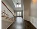 Bright living room featuring hardwood floors, a staircase, and natural light at 1850 Cotillion Dr # 2416, Atlanta, GA 30338