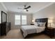 Well-lit main bedroom with neutral tones, fan, window, and dark wood furniture at 1850 Cotillion Dr # 2416, Atlanta, GA 30338