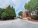 Brick building and tree-lined street create a serene neighborhood atmosphere at 1850 Cotillion Dr # 2416, Atlanta, GA 30338