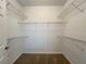 Walk-in closet has carpeted floor and metal shelving on all sides at 1850 Cotillion Dr # 2416, Atlanta, GA 30338